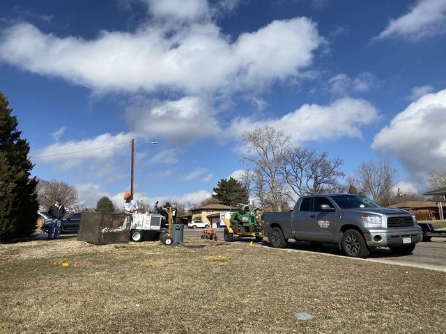 Gray Toyota Tundra and grinder at a job with safety screens set up in a dry front yard